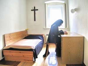 'A Discalced Carmelite nun sits in her cell, praying, meditating on the Bible', Melchior2006